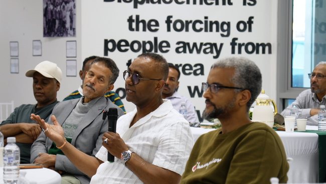 Guest speaking into a microphone at a community gathering