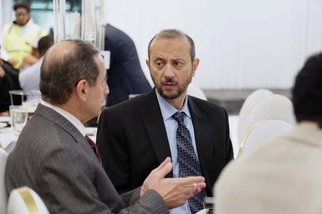 Two guests in conversation at a formal gathering