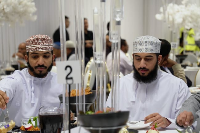 Two guests sharing a meal at a reception